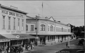 Downtown Hilo, Hawaii Island. Hilo Drug Co., Ltd. near left and American Factors across street.- ca 1928